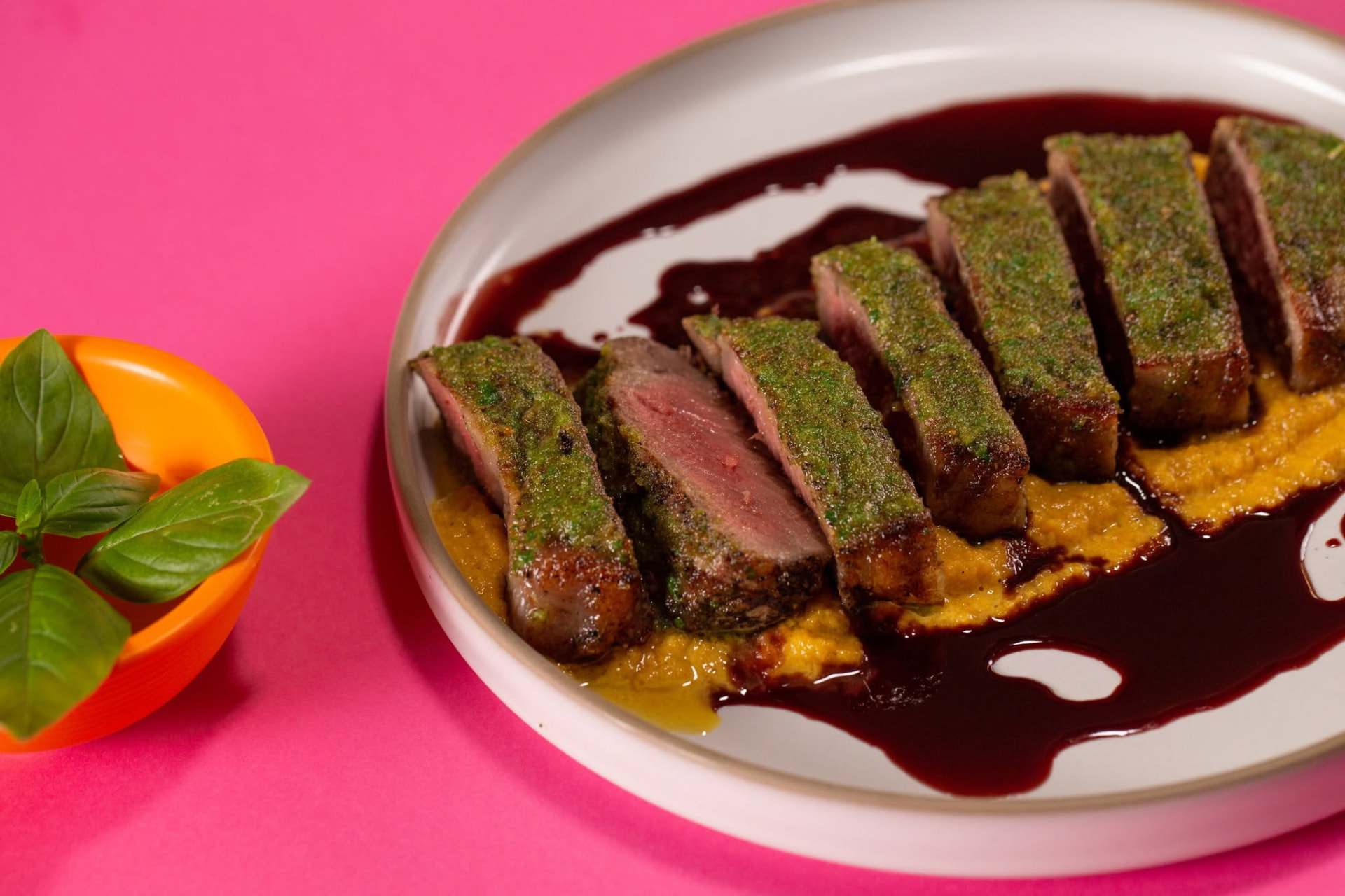 Sliced meat with herb crust and rich sauce
